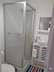 a bathroom with a shower and a sink at La Plage in Fécamp