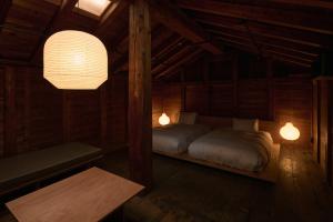 a bedroom with two beds in a wooden cabin at 安宅ノ宿 沖 in Komatsu