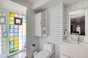 a bathroom with a toilet and a sink and a mirror at Comfort Suites Tijuana in Tijuana