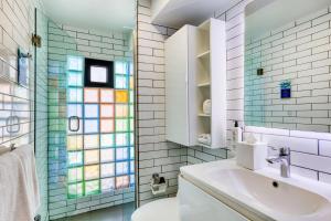 a bathroom with a sink and a glass shower at Comfort Suites Tijuana in Tijuana