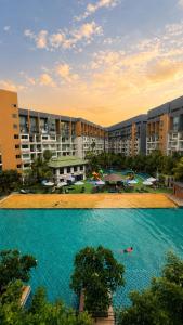 a large swimming pool in front of a large building at Pattaya Laguna Beach Resort 2 in Nong Prue