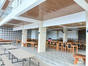 a dining area with tables and chairs in a cafeteria at Highlights Taal Lake View Resort in Santol