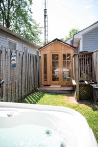 a house with a wooden fence and a tub at Fall Getaway|Crystal Beach Passes|Hottub|FirePit in Fort Erie