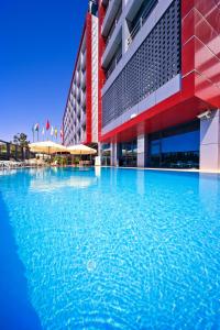 a large swimming pool in front of a building at Volley Hotel Istanbul in Istanbul