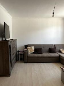 a living room with a couch and a tv at Diamond Resort Cottage Issyk-Kul in Bosteri