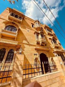 a yellow building with a fence in front of it at Vedsa haveli new in Udaipur