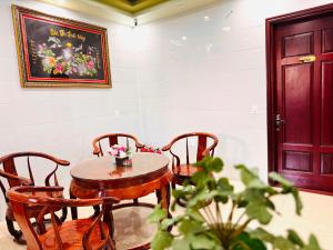a table and chairs in a room with a door at Thịnh Vượng Hotel in Dong Hoi