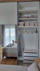 a bedroom with a bed and a closet with a mirror at D&M Lux2 in Podgorica