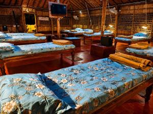 a room with a bunch of beds in it at Gowri Guest House in Hampi