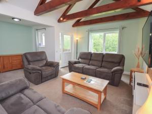 a living room with two couches and a coffee table at Whitbarrow 24 in Penrith