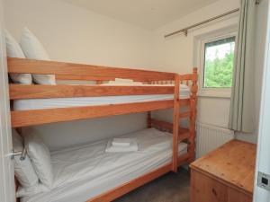 two bunk beds in a room with a window at Whitbarrow 24 in Penrith +19 photos