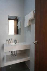 a white bathroom with a sink and a mirror at Reka Homestay in Thôn Dương Phẩm +14 photos