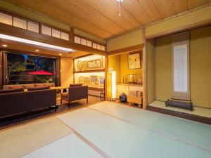 a living room with a couch and a table at Gallery NICO Osaka Yao in Yaochō