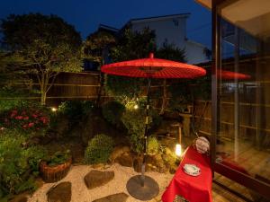 a red umbrella sitting on top of a patio at Gallery NICO Osaka Yao in Yaochō