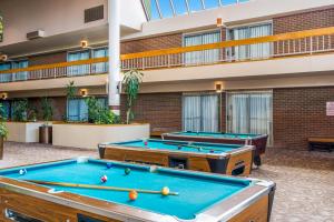 two pool tables in a courtyard with a building at Clarion Inn Grand Junction Airport in Grand Junction