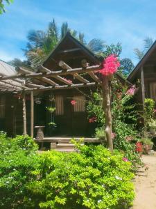 a house with a bunch of flowers in front of it at Silaa Cabana in Trincomalee