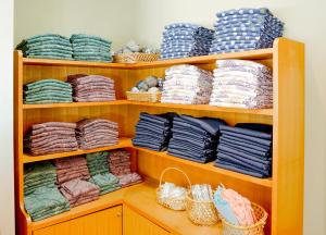 a wooden shelf filled with lots of plates and baskets at Shibuonsen YAMAICHIYA in Yamanouchi