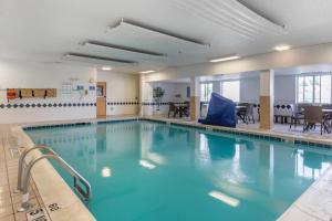 a large swimming pool with blue water at Comfort Inn Charlotte in Charlotte