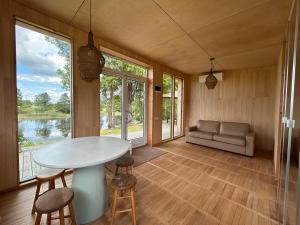 a room with a table and chairs and a couch at Pagalėlių namai in Voveriai