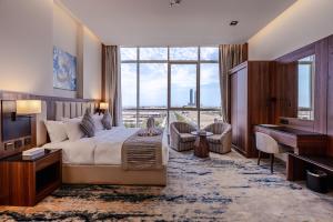 a bedroom with a bed and a large window at فندق كورنيت النورس - جدة in Jeddah +49 photos