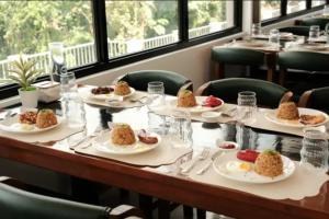 a table in a restaurant with plates of food at Highlights Taal Lake View Resort in Santol +4 photos