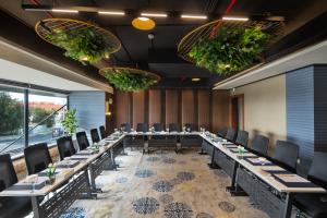 a large conference room with long tables and chairs at فندق كورنيت النورس - جدة in Jeddah