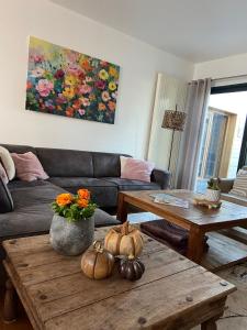 a living room with a couch and a table with pumpkins at Maison Patisson in Kasterlee
