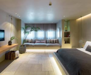 a living room with a bed and a couch at OMM INN in Eskisehir