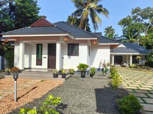 a house with a pathway in front of it at Casa Luminaria in Alleppey +21 photos