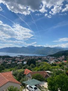 a view of a city and a river and mountains at Purple Haze Apartments in Tivat