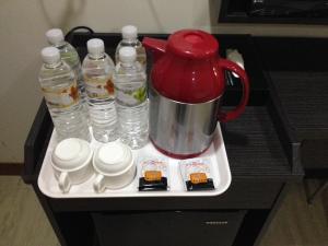 a tea pot and bottles of water on a tray at Big Bear Hotel in Kaohsiung