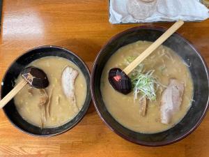 two bowls of food with chopsticks on a table at すすき野　ルミエール札幌 in Sapporo