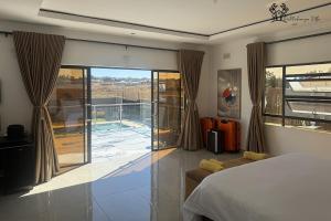 a bedroom with a bed and a view of a patio at Holiday Villa Marondera in Marondera +57 photos