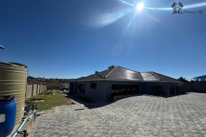 a house with a large patio in front of it at Holiday Villa Marondera in Marondera
