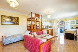 a living room with a couch and a kitchen at Spacious 2BR Apartment with Balconies in Karpathos