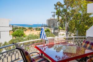 a table on a balcony with a view of the ocean at Spacious 2BR Apartment with Balconies in Karpathos