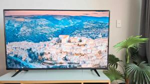 a television screen with a picture of a city at Darwin Harbour Sunset Views in Darwin