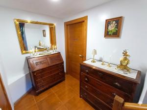 a bathroom with a wooden dresser and a mirror at Casa Vacacional Villa Martina in Valmeo +34 photos