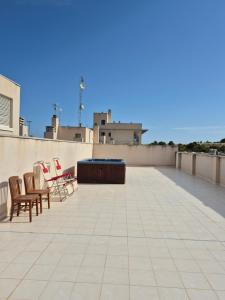 a patio with chairs and a table on a roof at Aire de Levante in Alicante