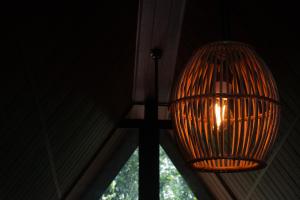 a hanging light in a room with a window at Nine Mist Heaven in Ella