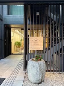 a building with a sign in front of a building at 女性専用 Woman Only capsule MAJA HOTEL KYOTO マヤホテルキョウト in Kyoto