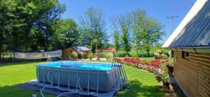 a swimming pool in a yard next to a house at Vikendica Anastasija in Laktaši