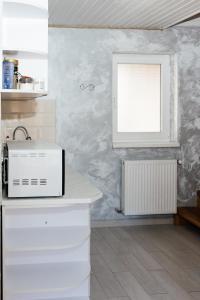 a kitchen with white cabinets and a window at Melody Hotel in Bukovel +272 photos