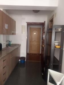 a kitchen with a door in the middle of it at Estudio Plazamar in Torre del Mar