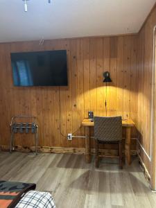 a room with a table and a television on a wall at Columbia Point Resort in Kettle Falls