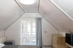 a room with a bed and a window in a attic at Melody Hotel in Bukovel