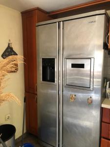 a stainless steel refrigerator with a microwave on it at A house with the view in Bar