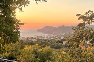 a view of a city at sunset with mountains at A house with the view in Bar