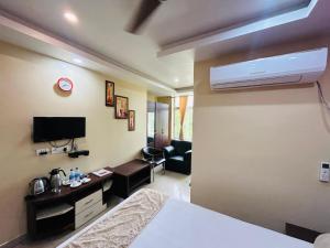 a hotel room with a bed and a living room at Hotel Sky View in Aurangābād