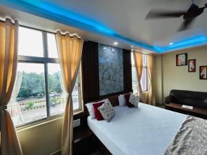 a bedroom with a bed and a large window at Hotel Sky View in Aurangābād